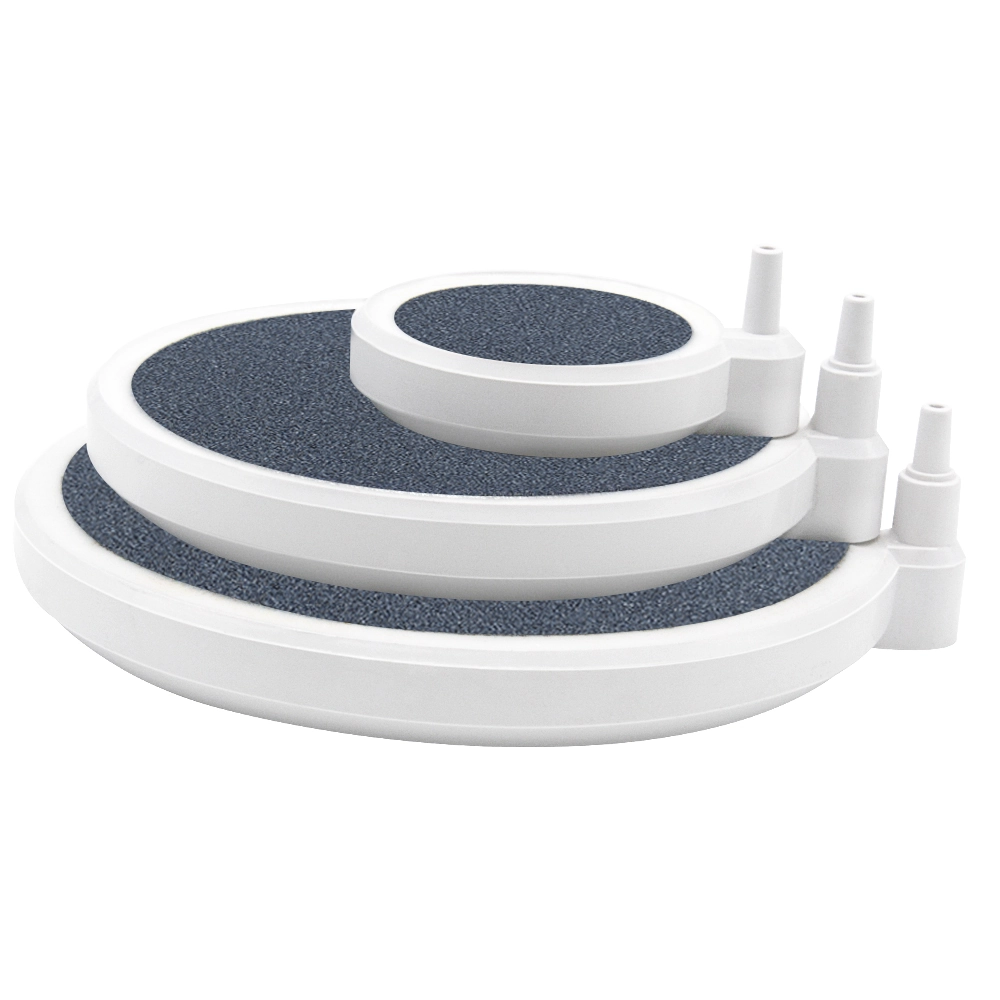 KOOI Blue Whale aquarium air stone discs in three sizes, stacked to show their white housings, dark stone surfaces and built-in airline connectors.