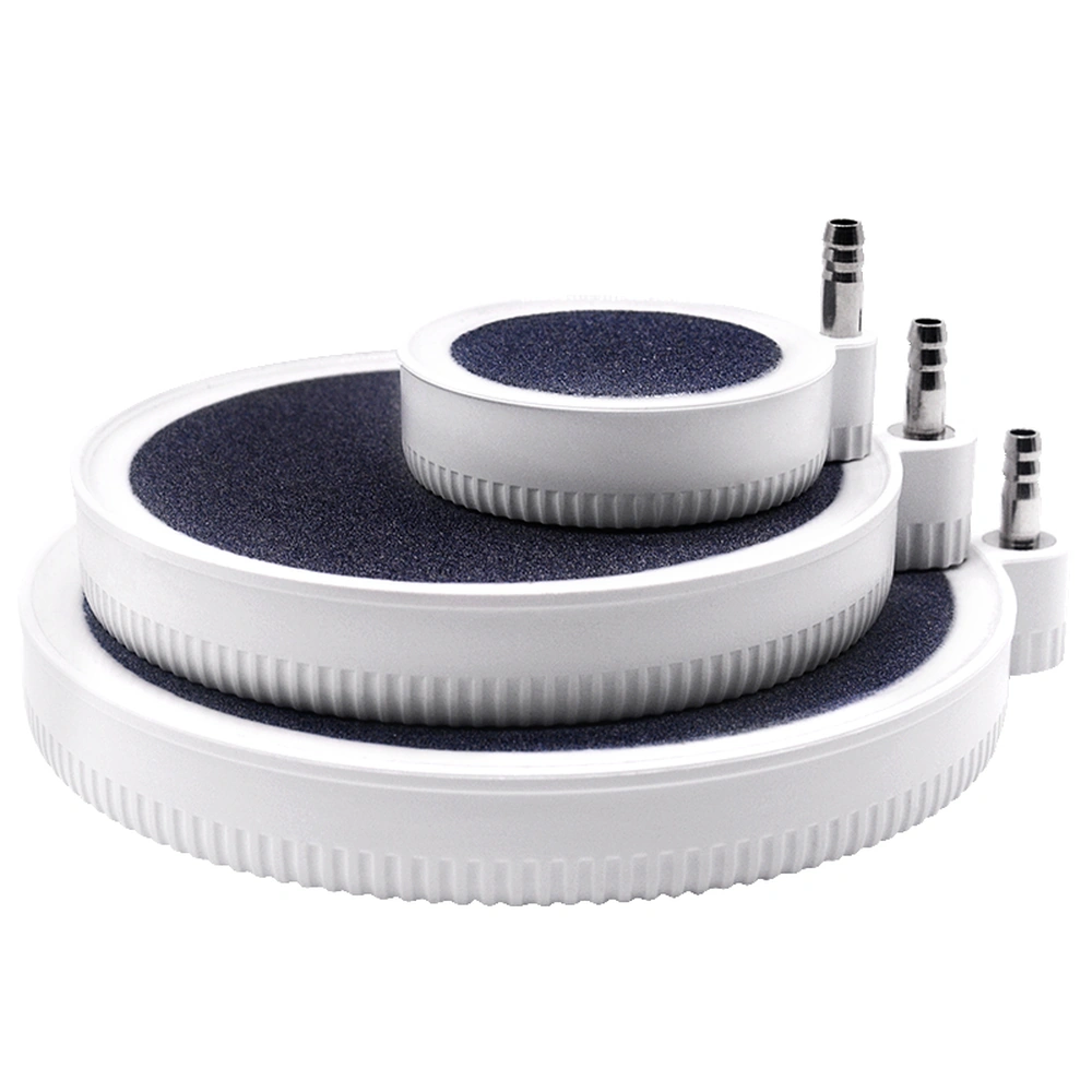 Beluga aquarium air diffuser discs in three sizes, with dark porous stone surfaces, white housings and airline inlets at the edge.