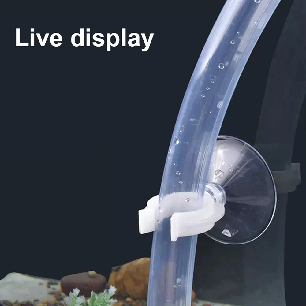 White aquarium tube clip holding clear tubing against the aquarium glass with a suction-cup mount.