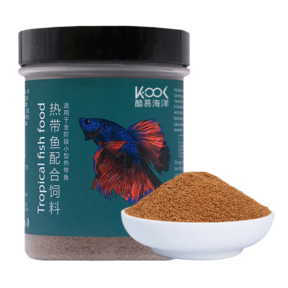 KOOI-YL-001 slow-sinking tropical fish food in a 55 g jar beside a bowl of fine granules.