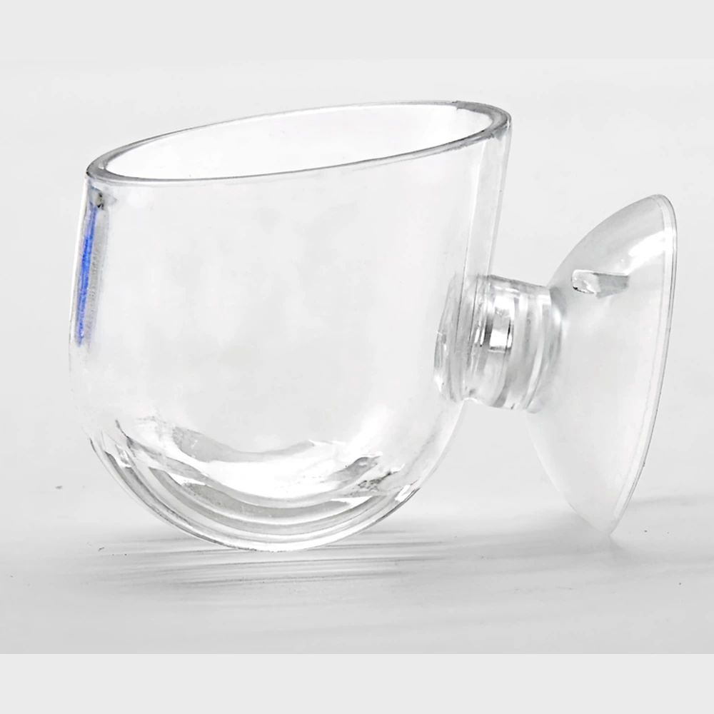 Clear aquarium bloodworm feeding cup with an open top, slotted base and side suction-cup mount.